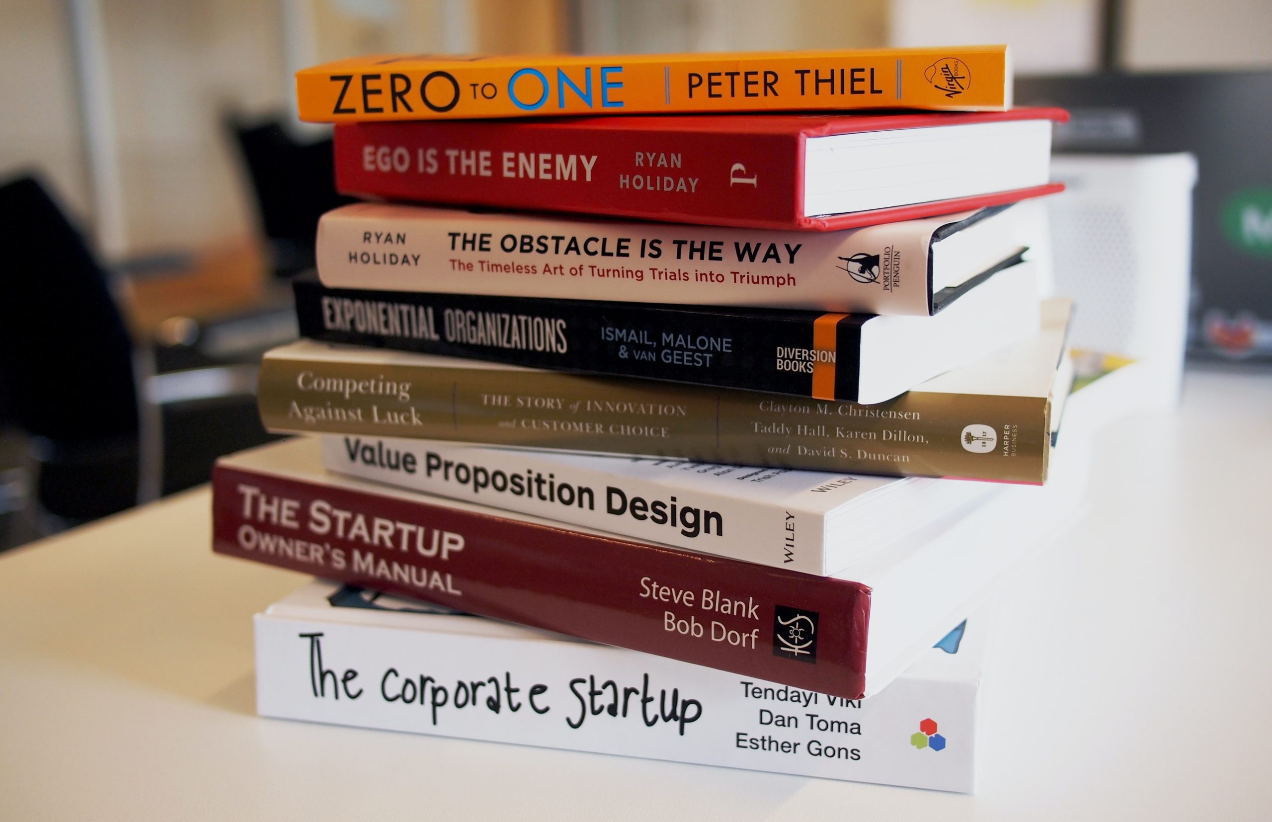 a stack of entrepreneurship books