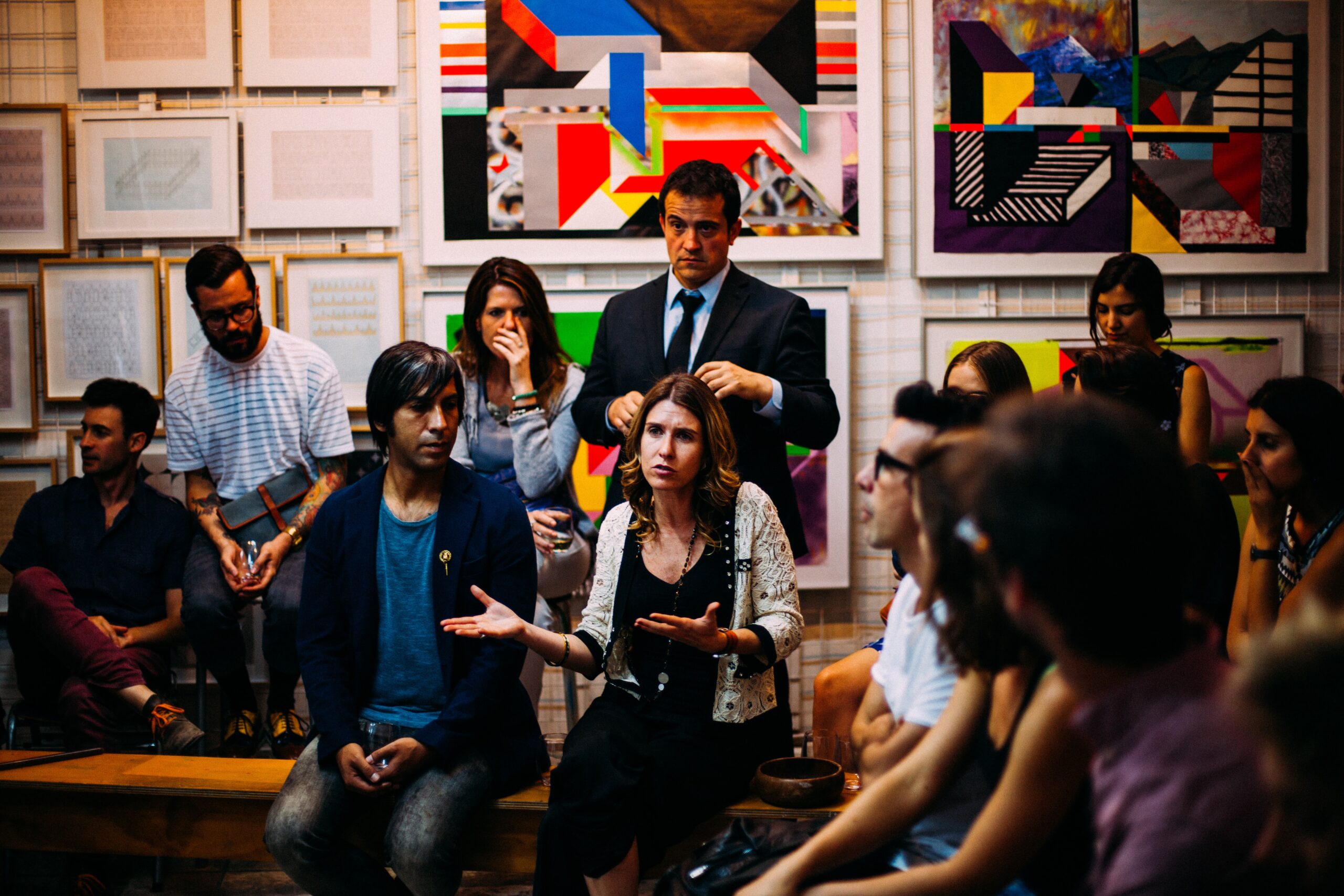 group of people talking in an art classroom